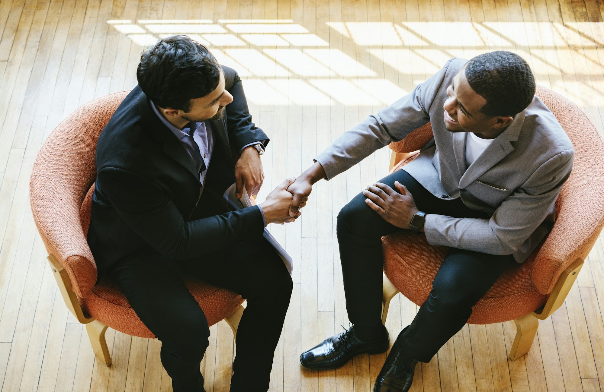 Businessmen shaking hands after making a deal to hire a consultant for their business